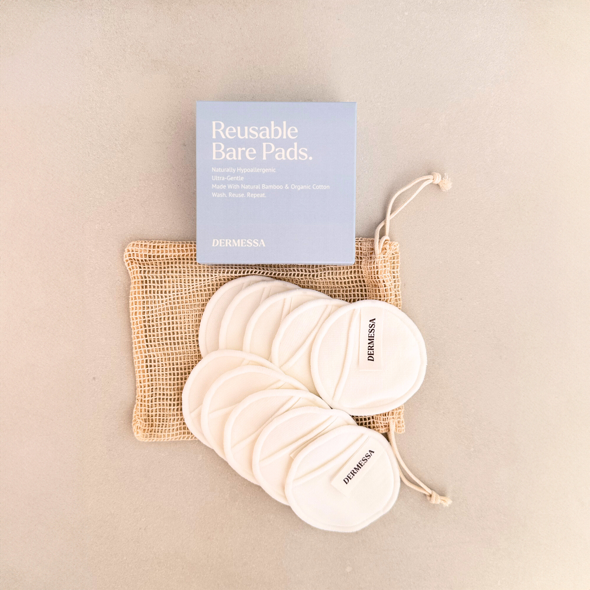 Reusable bare pads with a branded pouch on a beige background