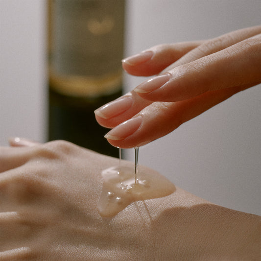 A white cosmetic jar of OOTD Snail Mucin Lifting Cream with natural ingredients for elasticity enhancement and repair technology.