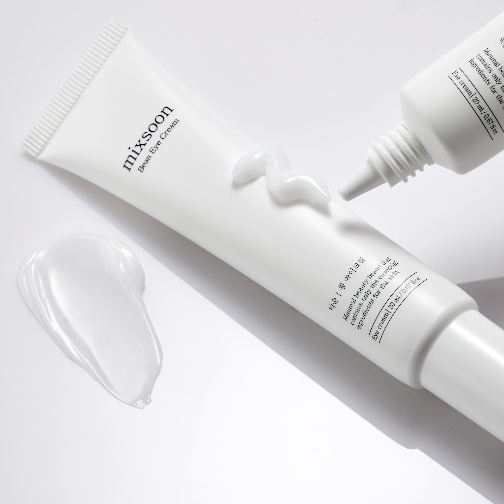 Mixsoon Bean Eye Cream tube with cream texture displayed, on a light background.