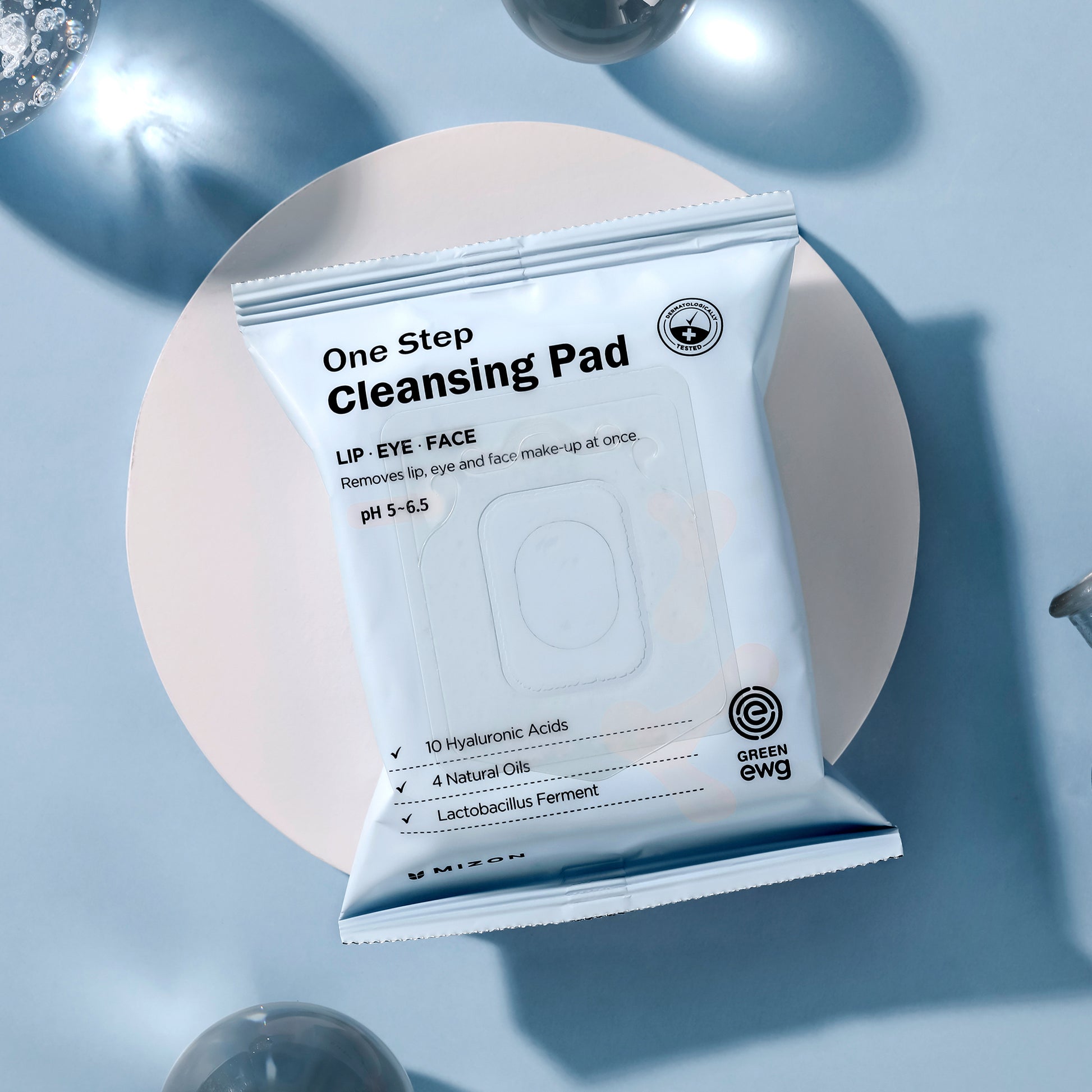 Mizon One Step Cleansing Pad package for lip, eye, and face makeup removal on a blue background.