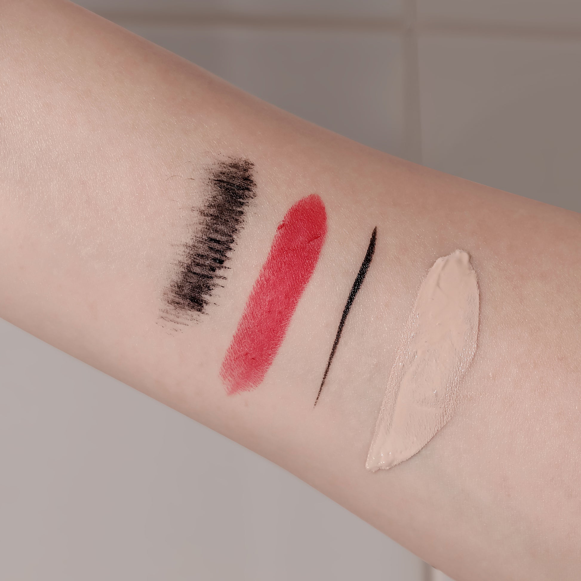 Skin swatches showing makeup removed by Brand One Step Cleansing Pad, demonstrating cleanser effectiveness.
