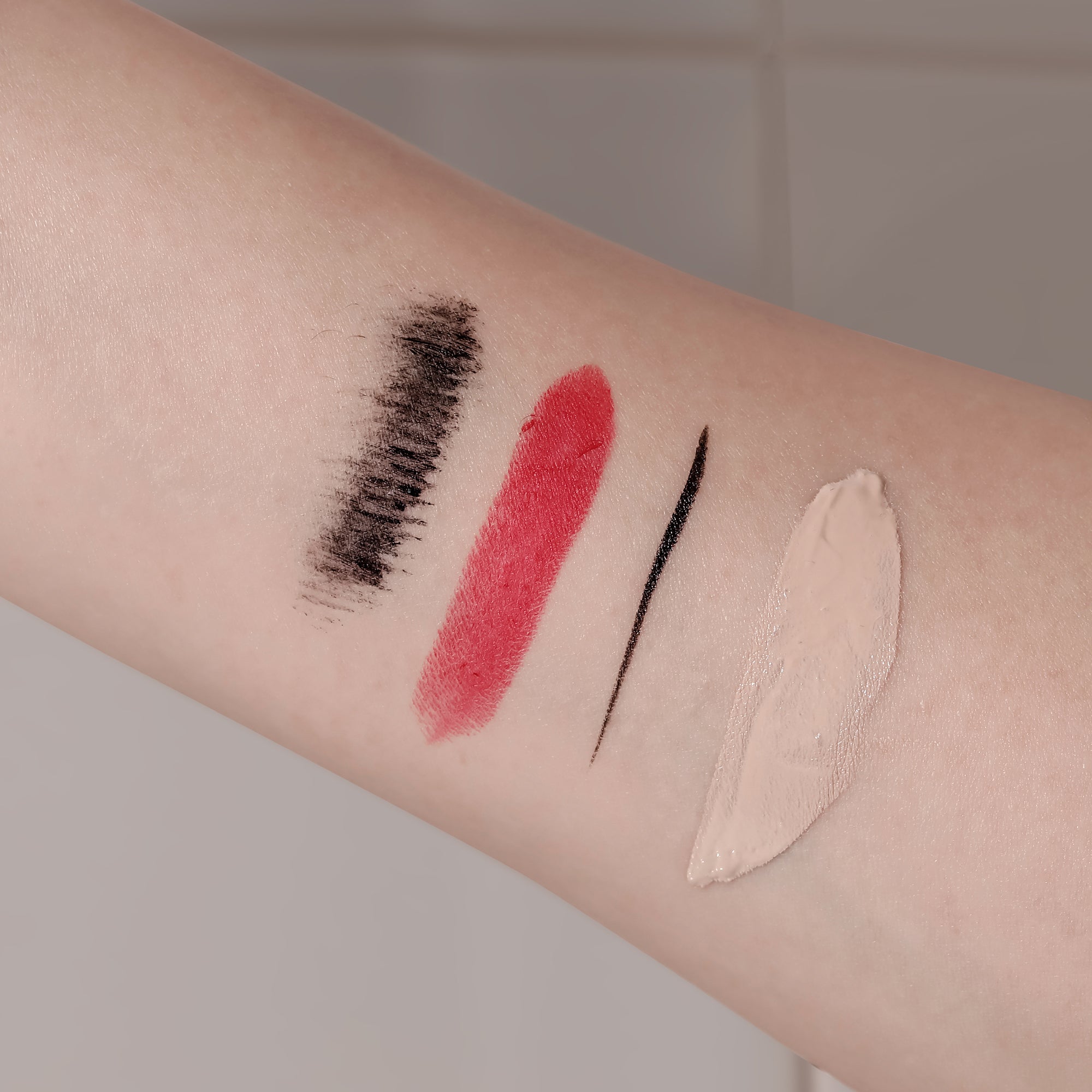 Skin swatches showing makeup removed by Brand One Step Cleansing Pad, demonstrating cleanser effectiveness.