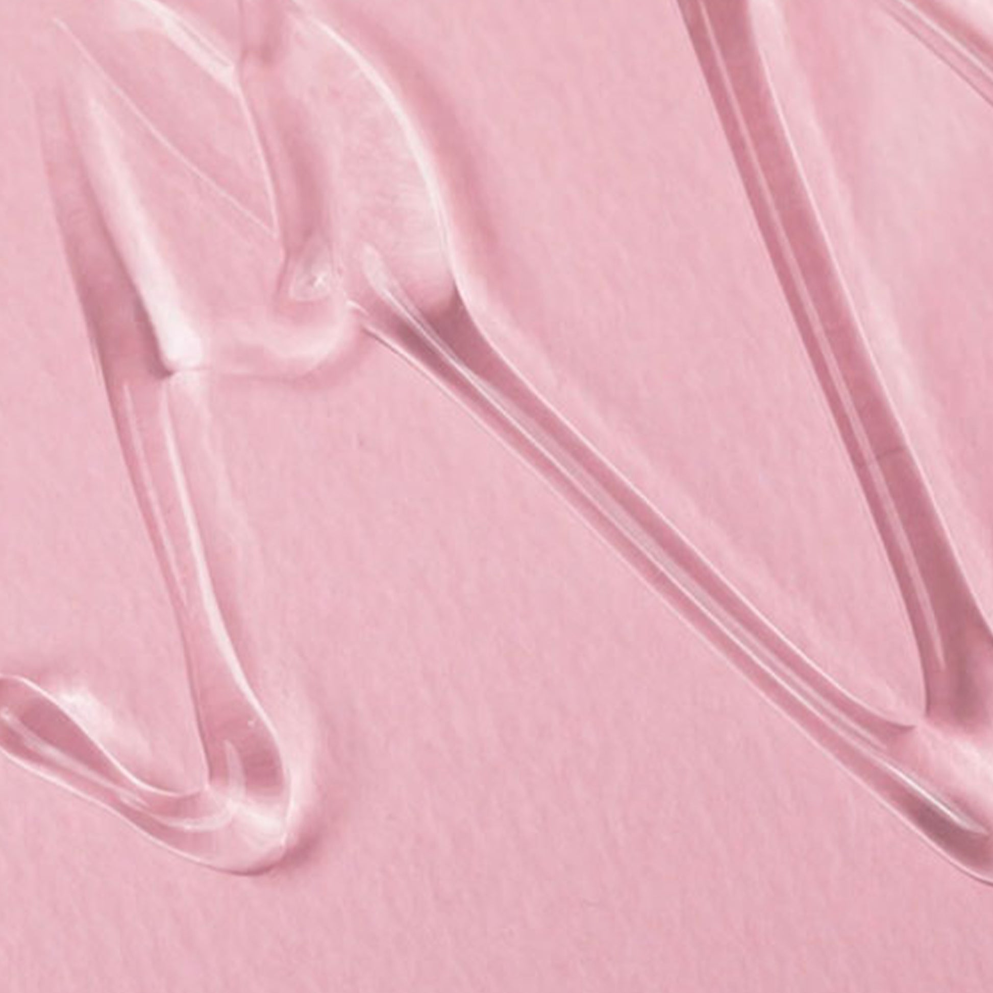 Close-up of clear gel on pink surface from Cosrx Goodbye Redness Centella Cica Gel.