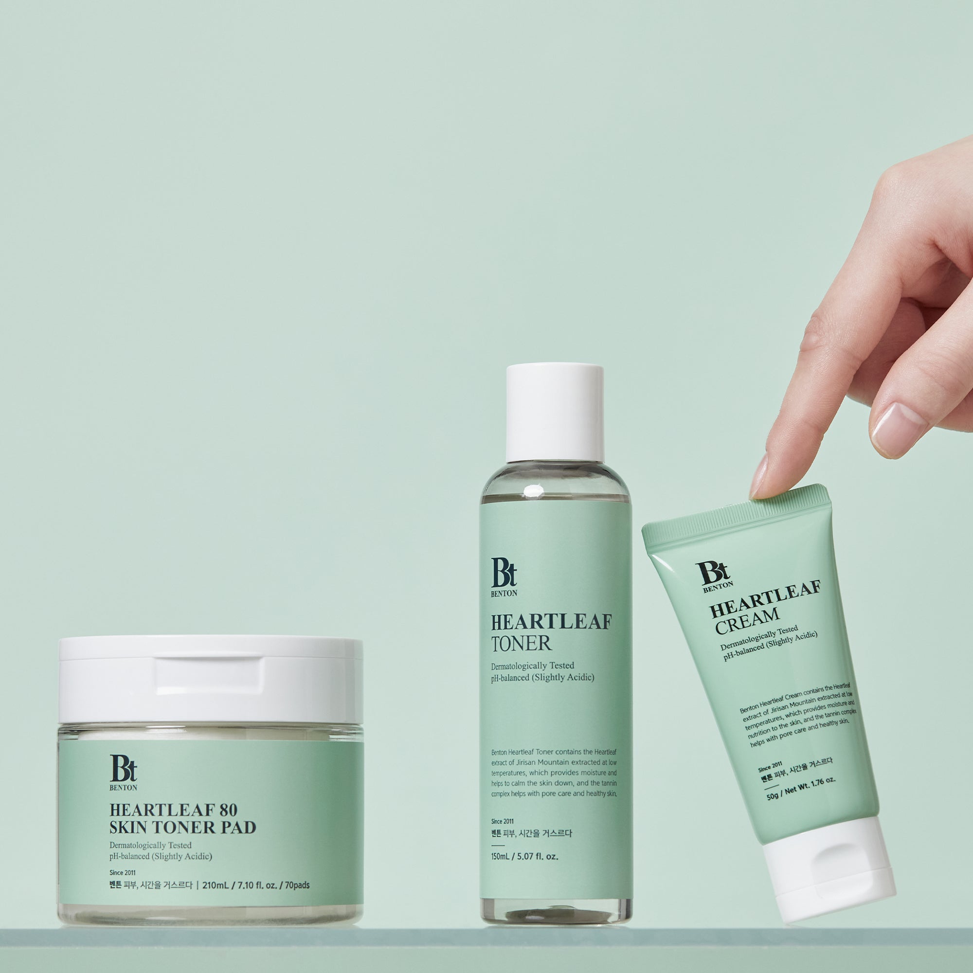 Benton Heartleaf 80 Skin Toner Pad, Toner, and Cream on mint background.