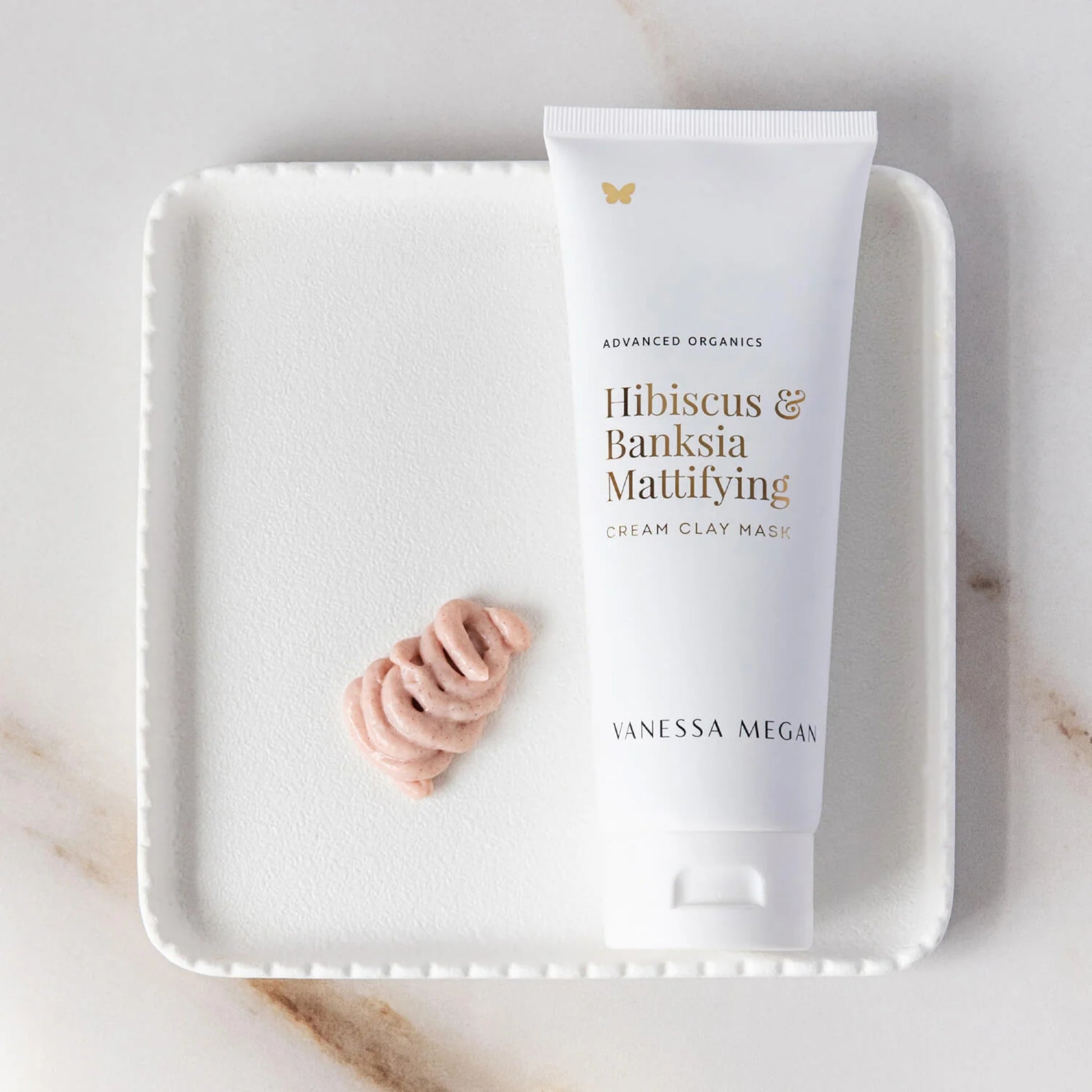 Vanessa Megan Hibiscus & Banksia Mattifying Clay Mask on a white tray with a marble background