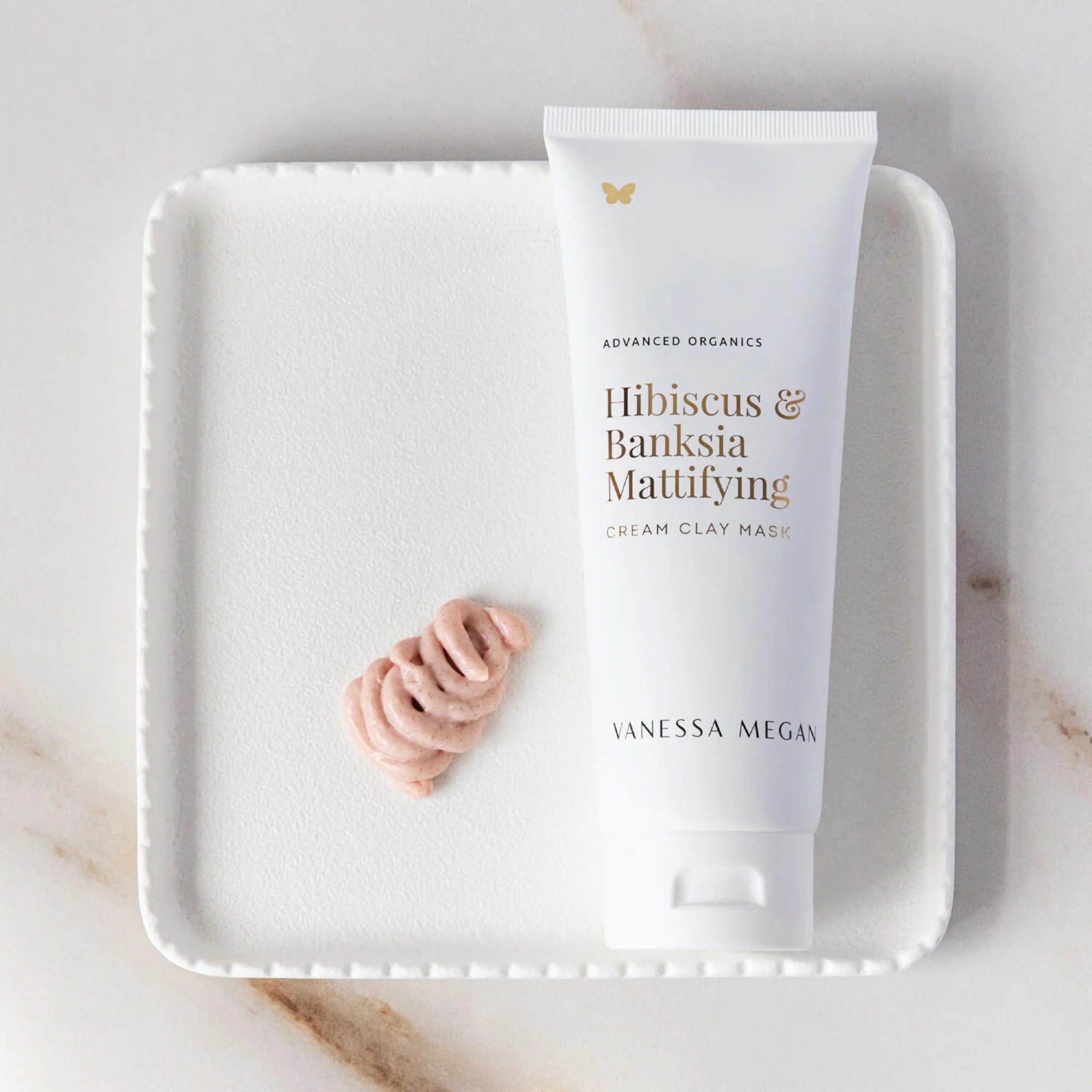 Vanessa Megan Hibiscus & Banksia Mattifying Clay Mask on a white tray with a marble background