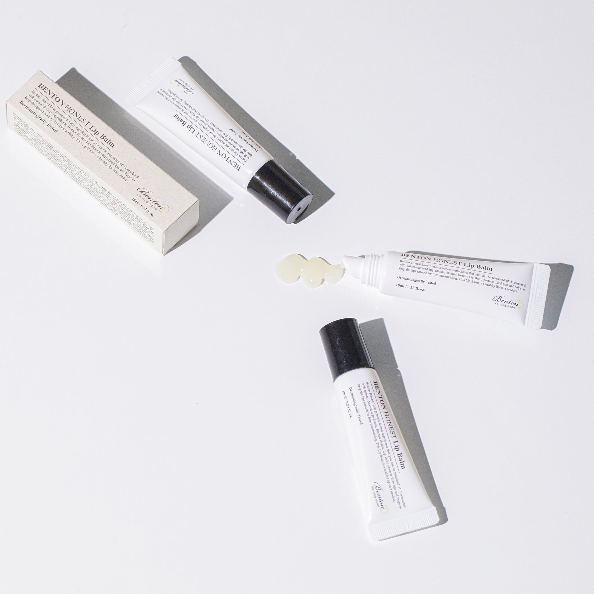 Benton Honest Lip Balm tubes and packaging on a white background, showing product texture.