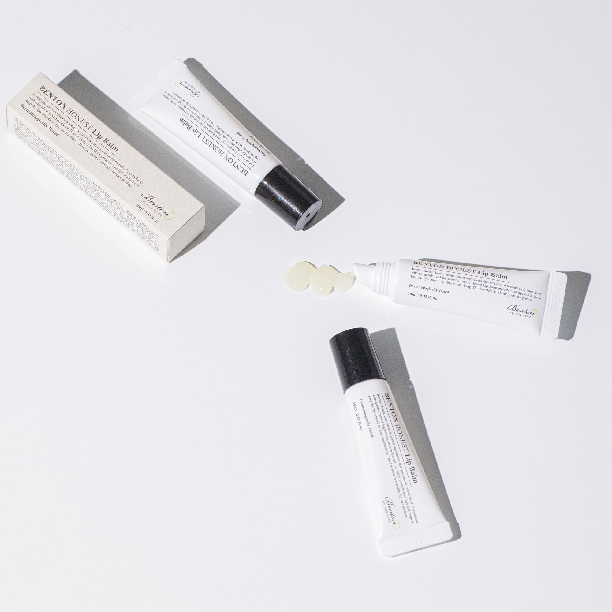 Benton Honest Lip Balm tubes and packaging on a white background, showing product texture.