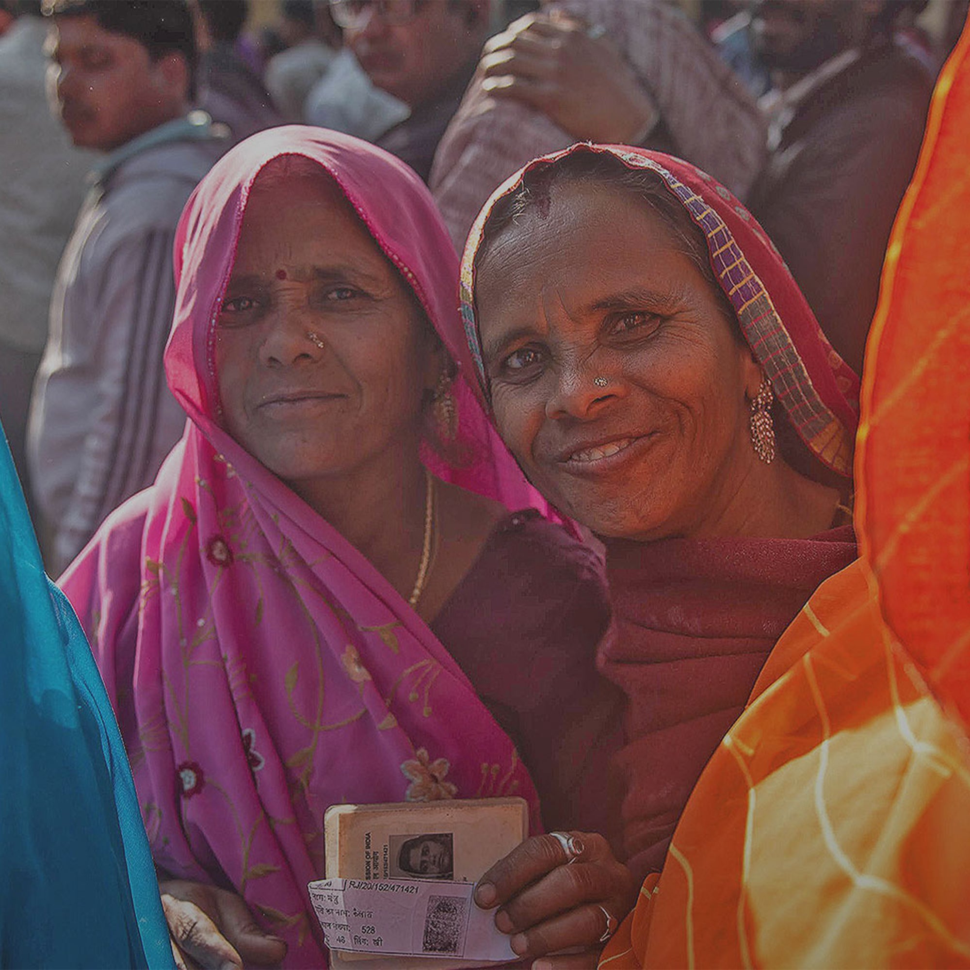Two Indian smiling as they hold a certificate
