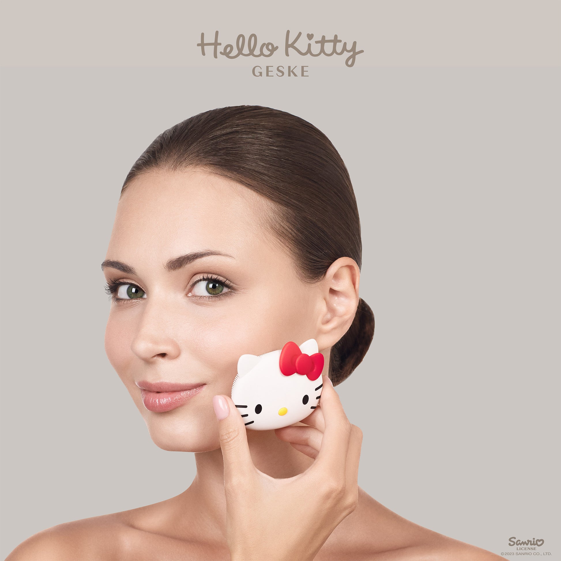 Woman using Hello Kitty facial brush for skincare routine.