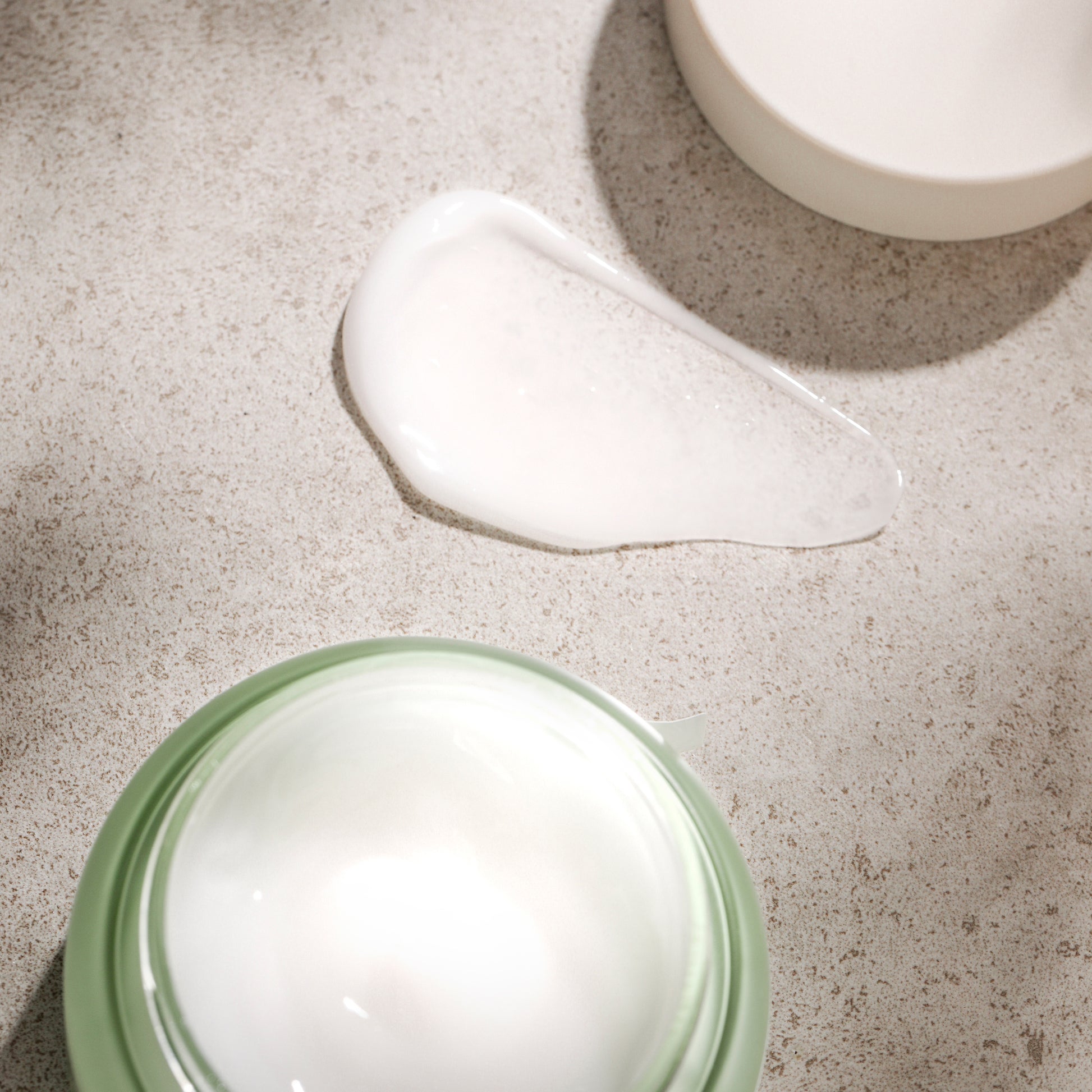 Phyto Plump Collagen Day Cream jar with cream texture on surface.
