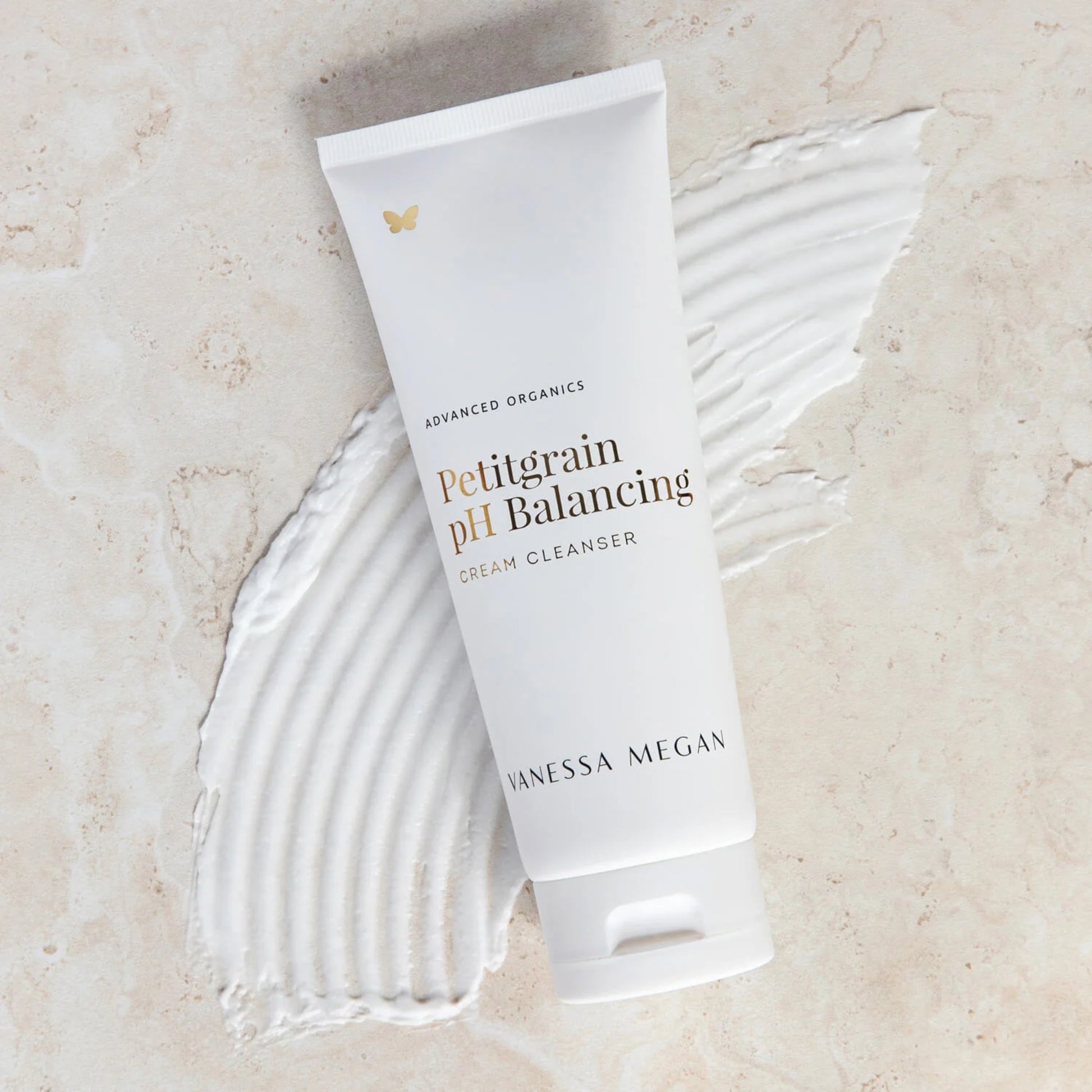 Tube of Vanessa Megan Petitgrain pH Balancing Cream Cleanser on a textured beige background