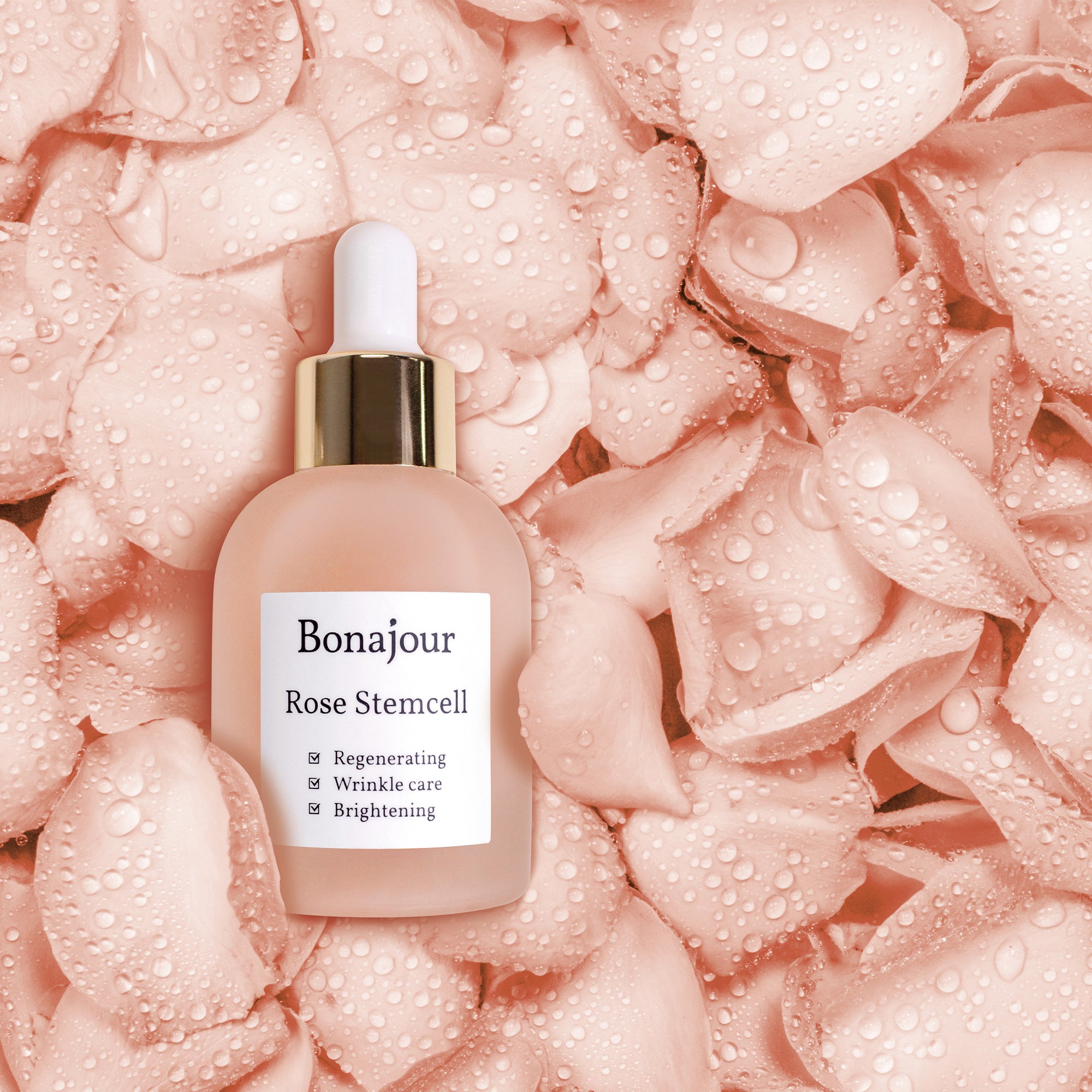 A bottle of Bonajour Rose Stem Cell Ampoule on a background of pink rose petals with water droplets. The ampoule is labeled for regenerating, wrinkle care, and brightening.