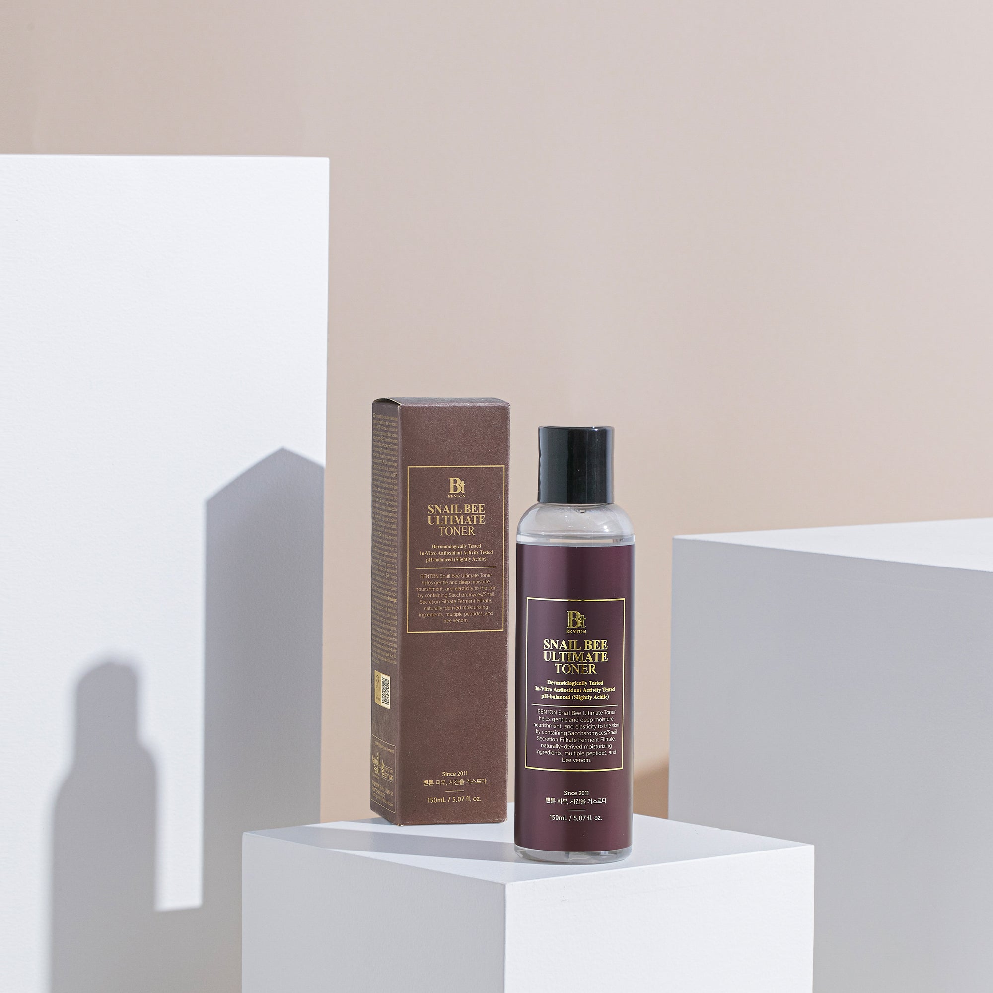 Benton Snail Bee Ultimate Toner with box on a minimalist background.