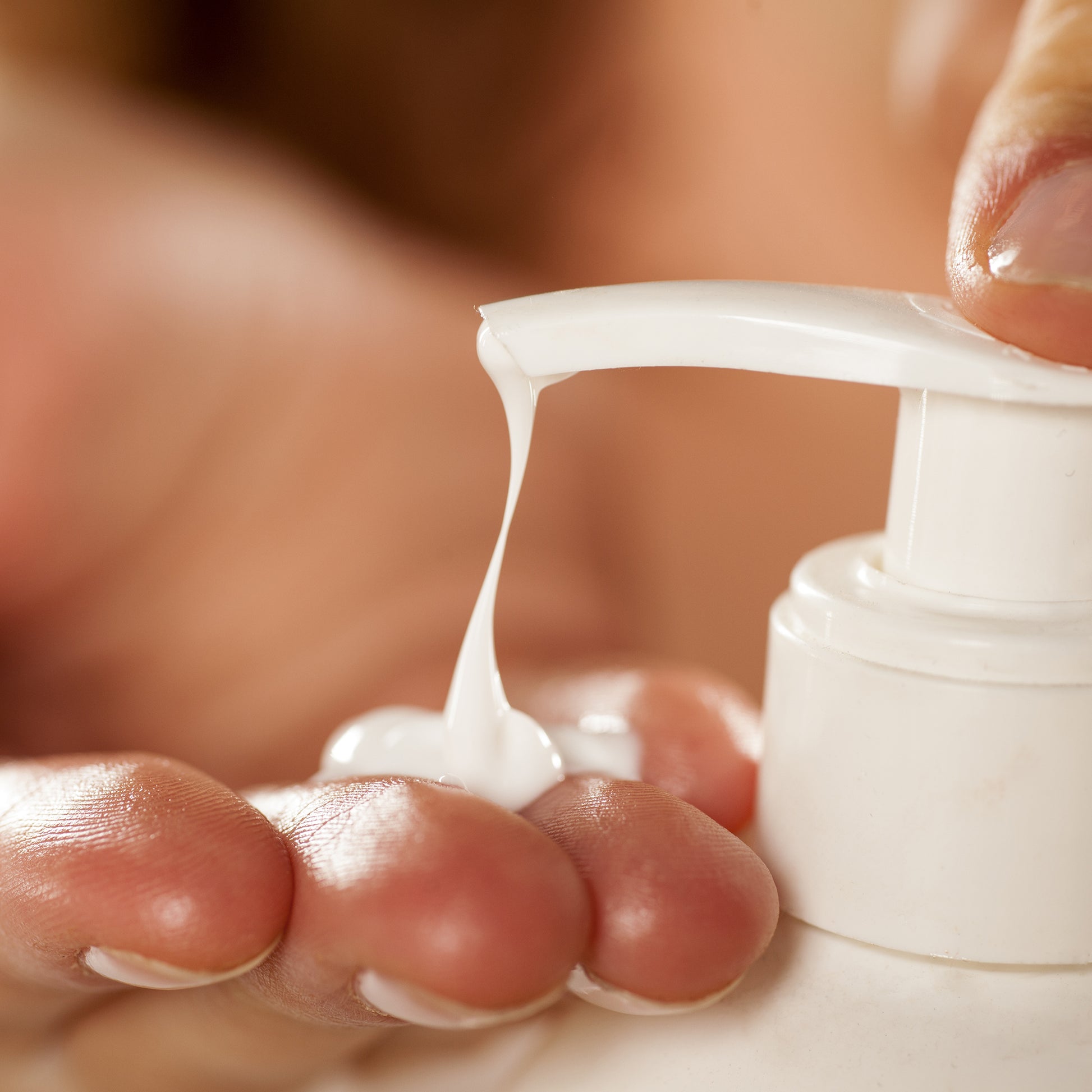 Tea Tree AC Control Body Lotion being dispensed onto a hand from a white pump bottle.