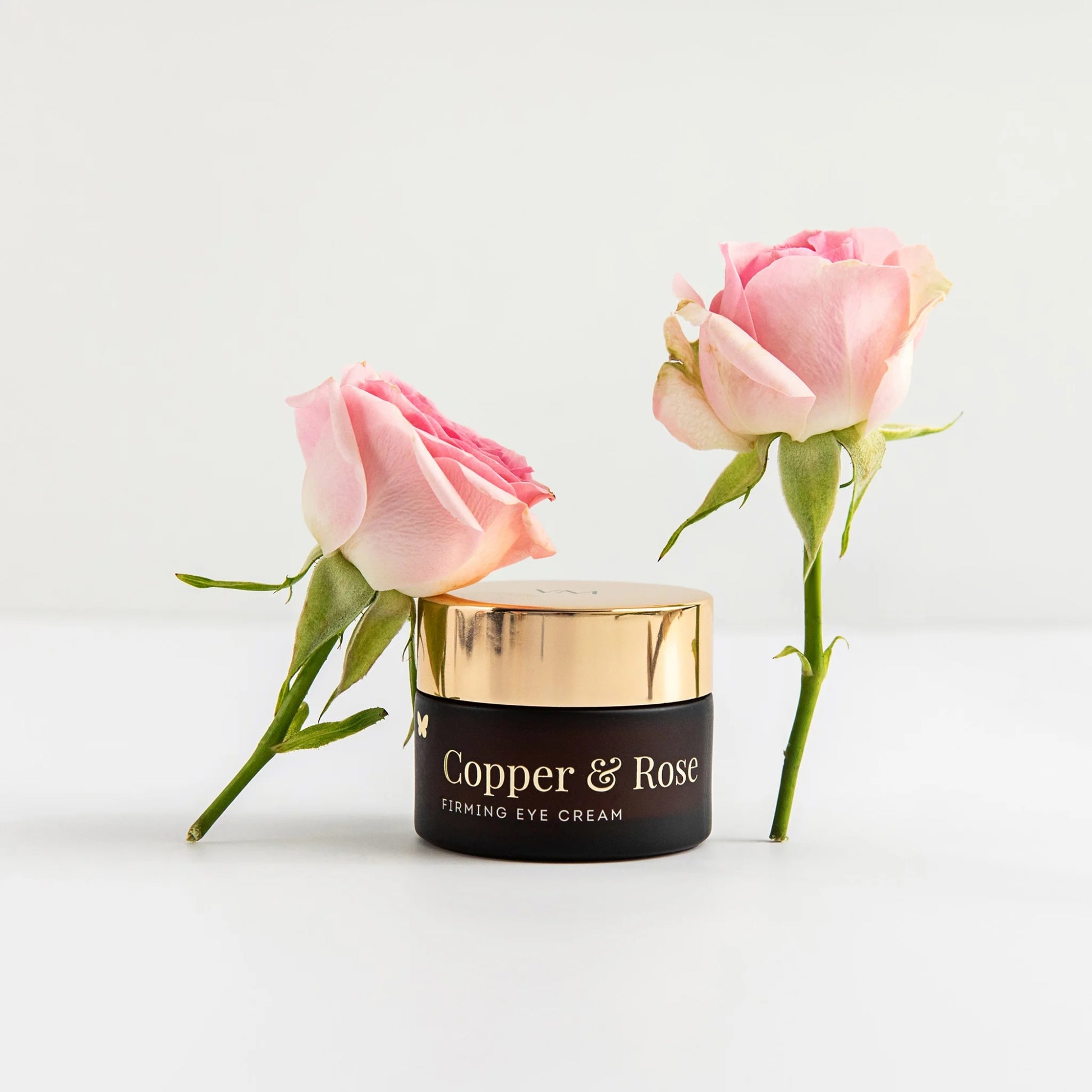 Vanessa Megan Copper & Rose Firming Eye Cream with pink roses on a light background