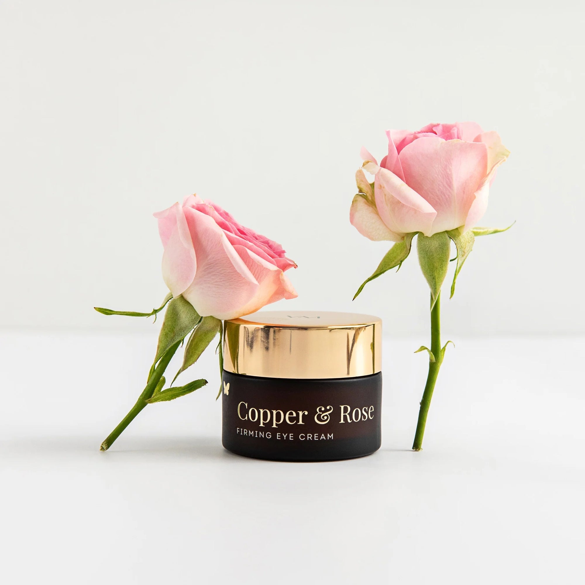 Vanessa Megan Copper & Rose Firming Eye Cream with pink roses on a light background