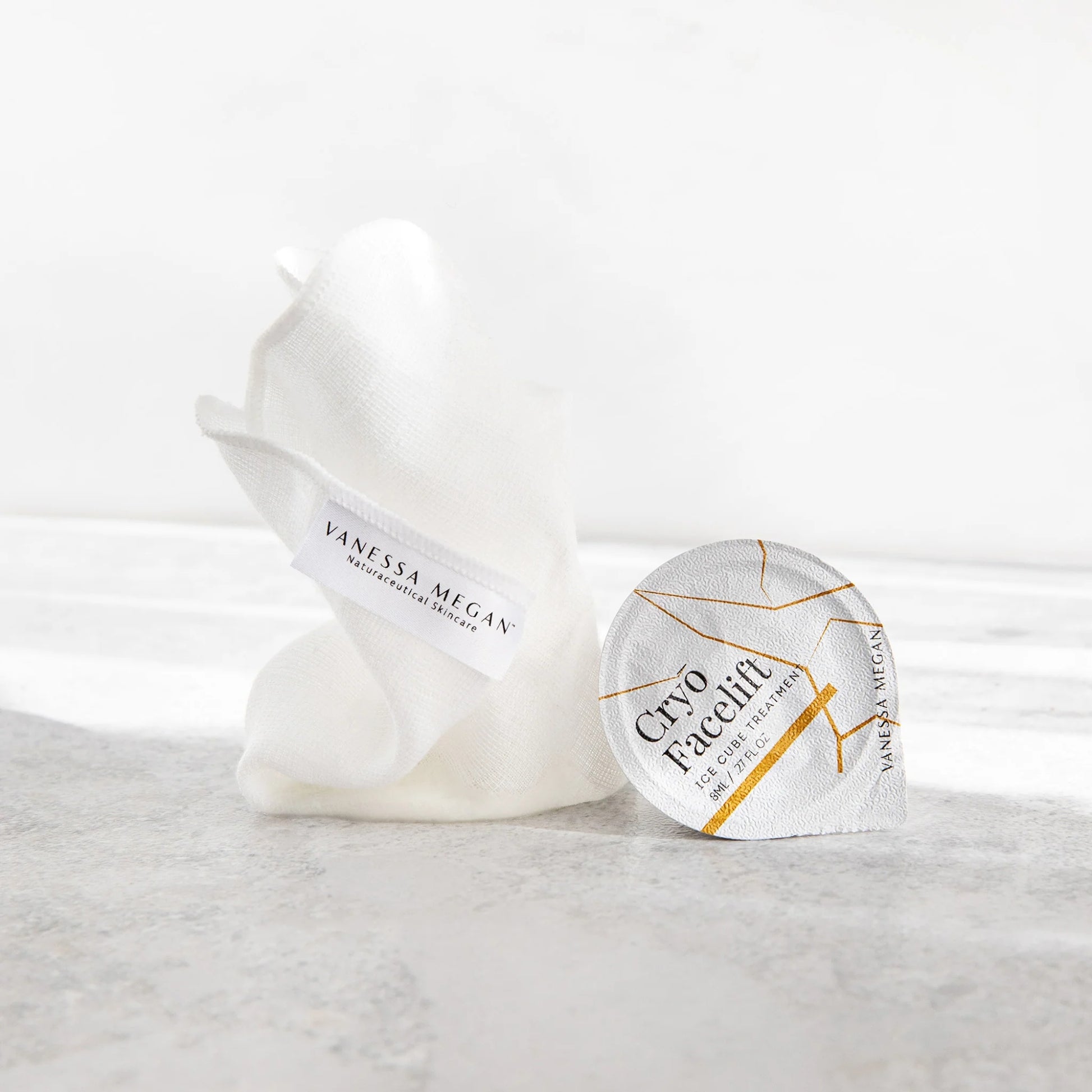 Vanessa Megan Cryo Facelift Ice Cube Treatment on a marble surface with a white background