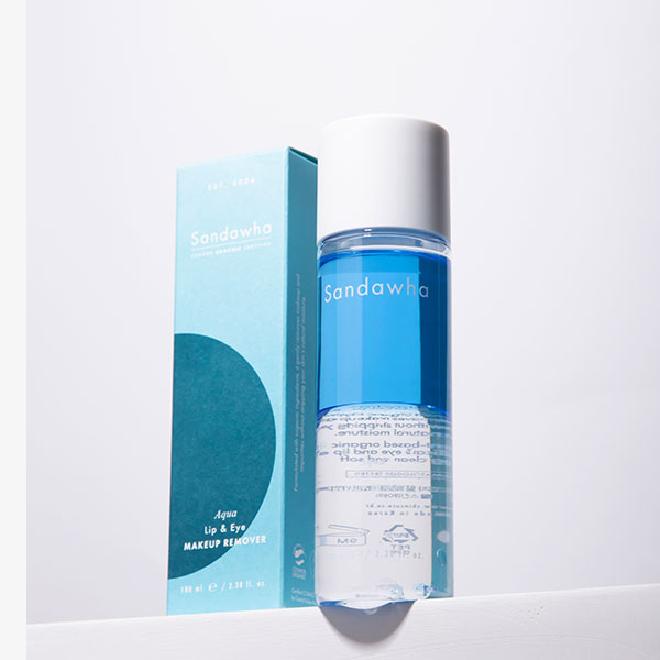 A bottle of Aqua Lip & Eye Make Up Remover, acclaimed as the best eye makeup remover, sits elegantly beside its blue and white packaging box.