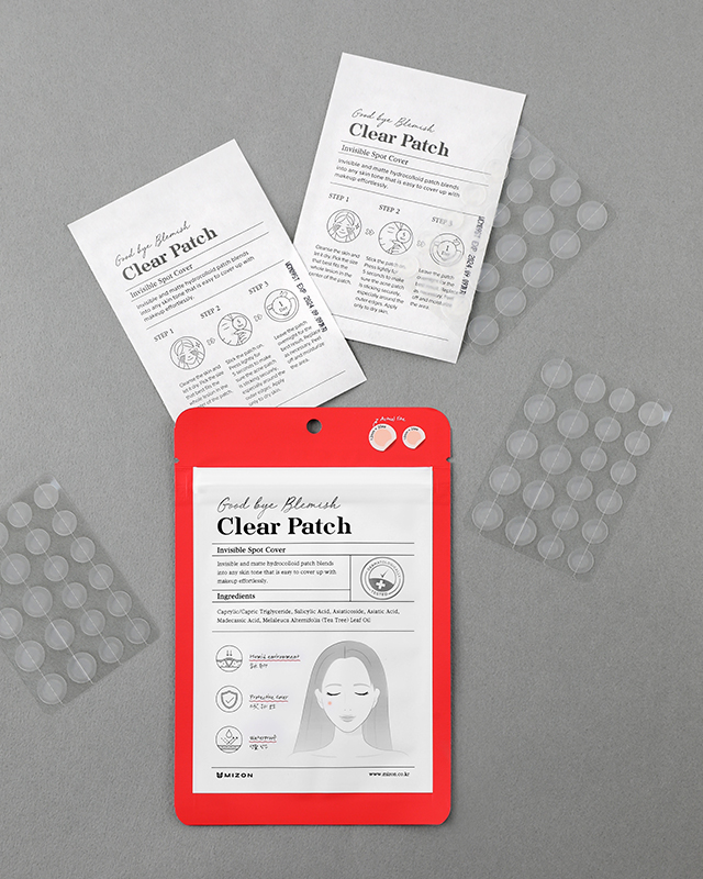 Acne patches and packaging on a gray background, featuring product details and small transparent patch sheets.