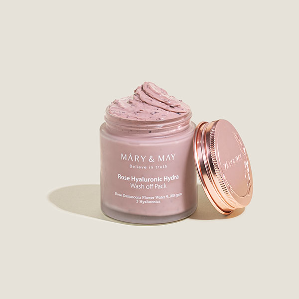 A jar of Rose Hyaluronic Wash Off Pack by Mary & May, with its lid open to reveal the pink cream inside, showcases its brightening rose clay mask enriched with rose water.